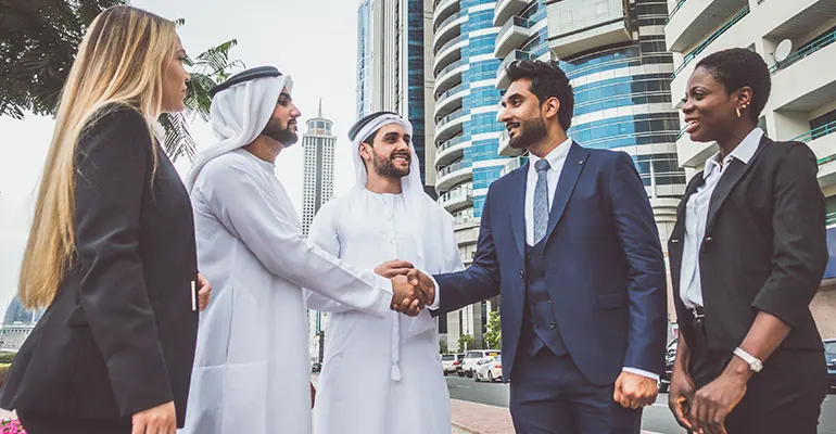 Cross-border investment team in a boardroom meeting