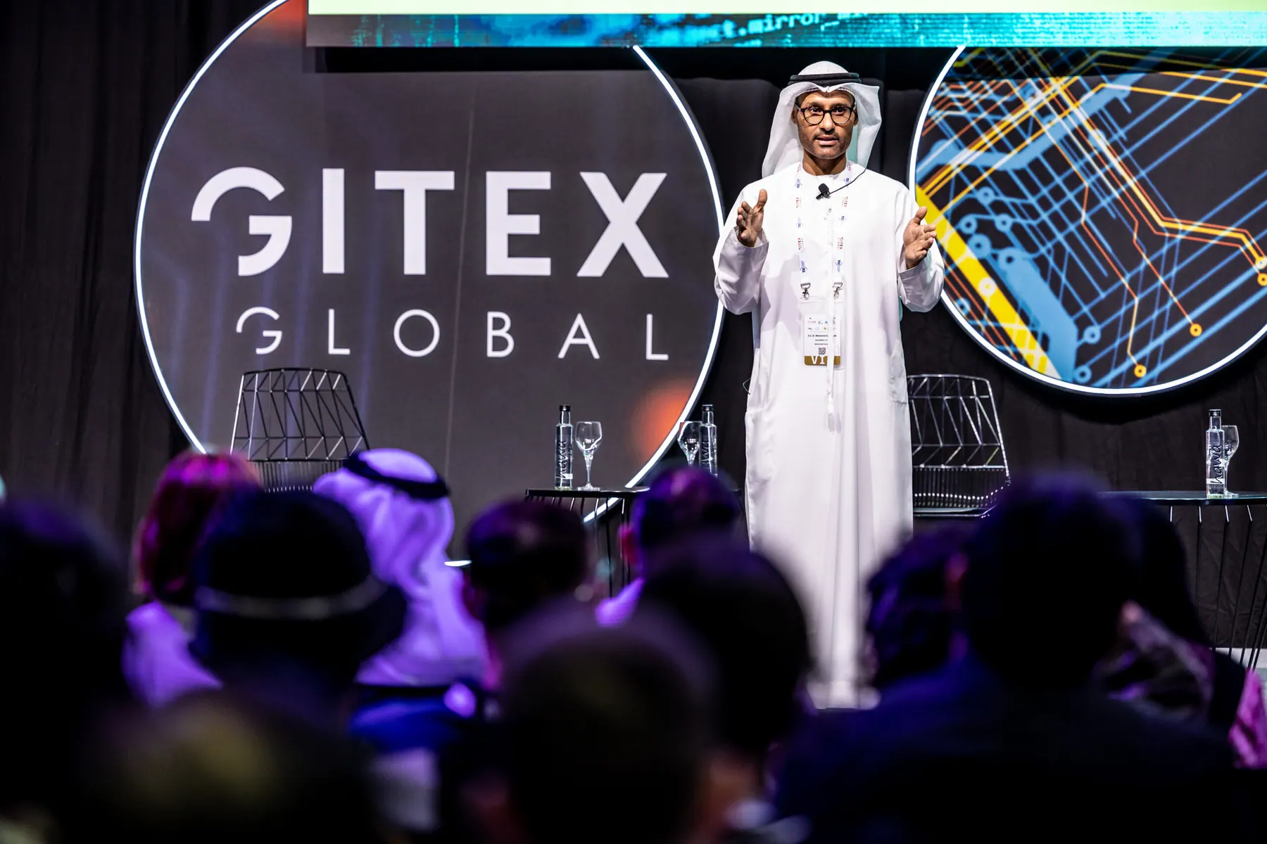 A speaker addressing the audience in front of the GITEX Global logo