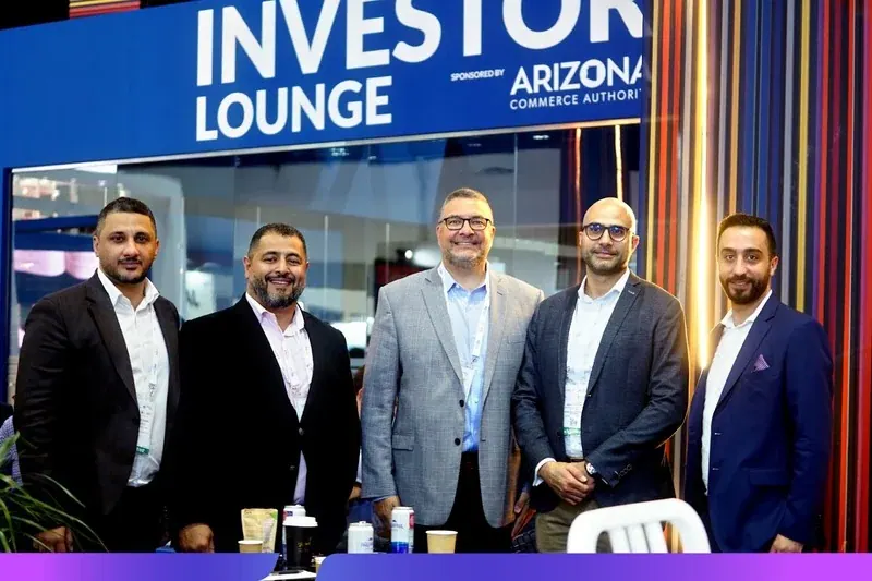 Delegates gathered at the Investor Lounge stand